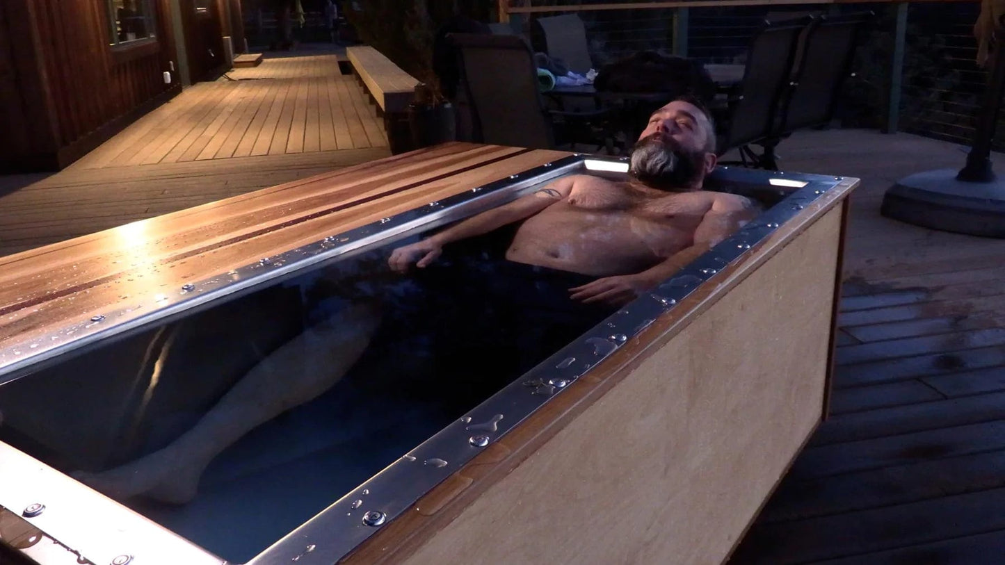 Man laying down in an in-line 46 cold plunge by BlueCube