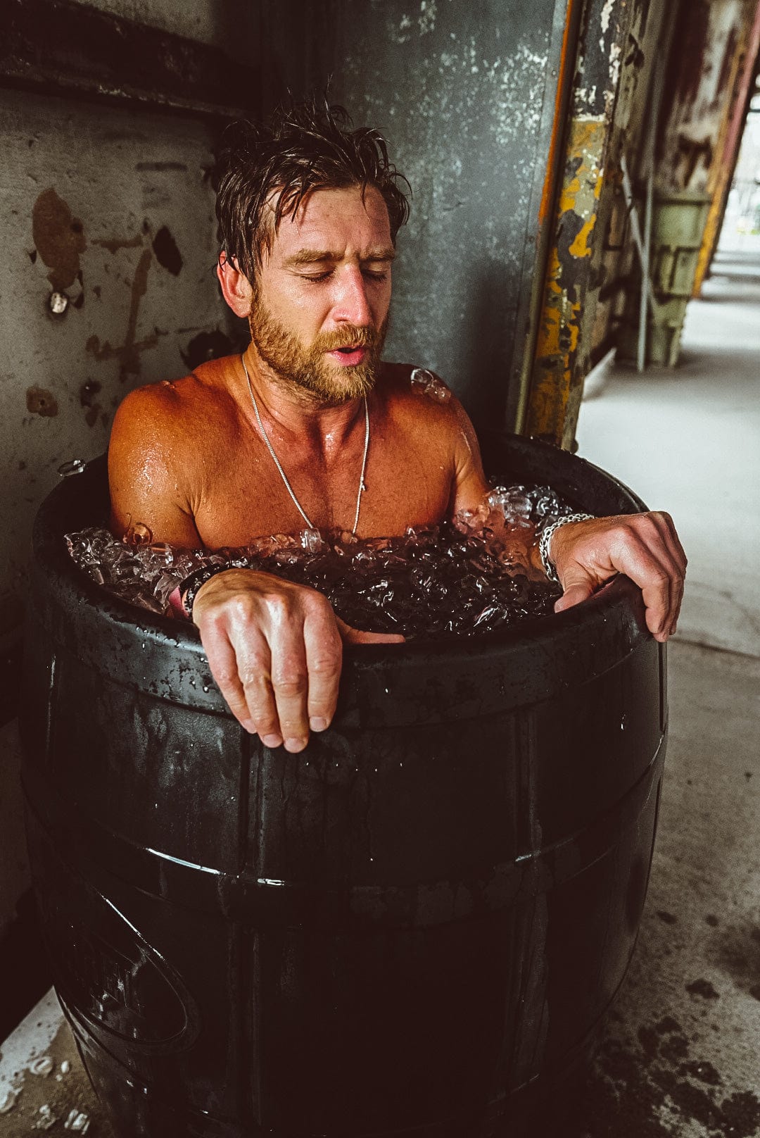 Man taking a breath while in a full ice bath by Ice Barrel 